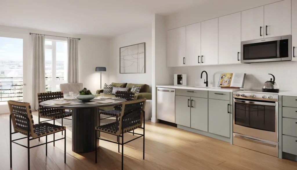 Modern open-concept kitchen and living area with light wood floors, white cabinets, round dining table with four chairs, sofa, coffee table, and large window with city view.